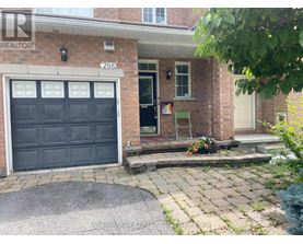 A house with a black garage door and a brick facade.