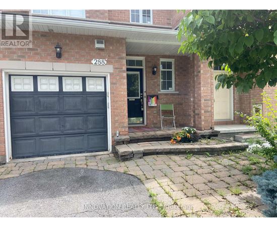 A house with a black garage door and a brick facade.