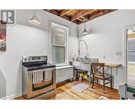A kitchen with a stove and a table.