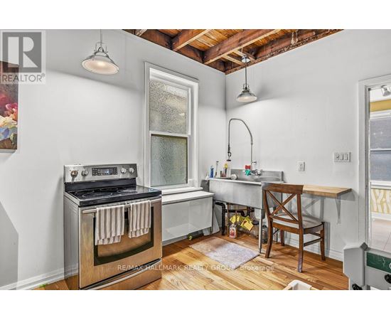 A kitchen with a stove and a table.