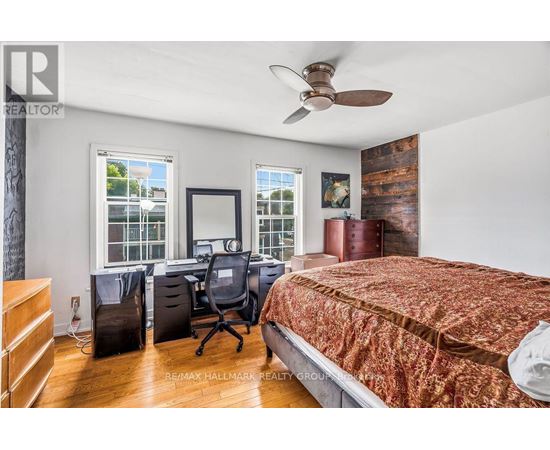 A bedroom with a bed, desk, and chair.