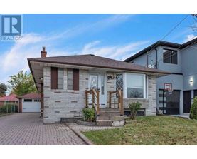 A house with a brown roof and a white garage door.