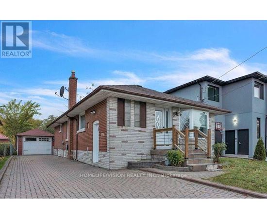 A brick house with a garage is for sale.