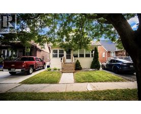 A red pickup truck is parked in front of a house.