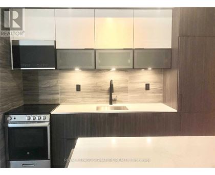 A modern kitchen with a stainless steel oven and a sink.