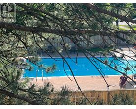 A person is standing by a blue pool.