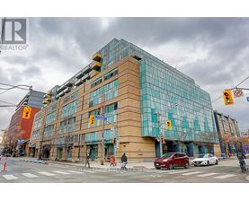 A modern building with a glass facade is the focal point of the image.