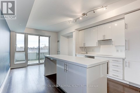 A kitchen with white cabinets and a large island.