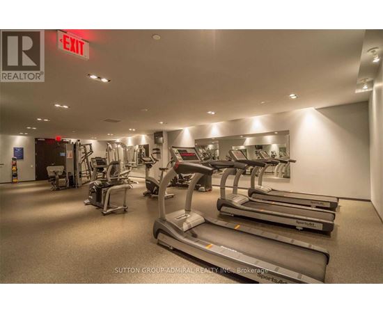 A gym with treadmills, elliptical machines and other exercise equipment.