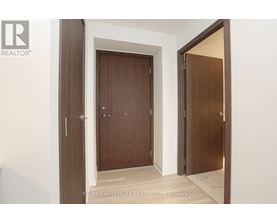 A brokerage sign is on the bottom left of a hallway with two doors.