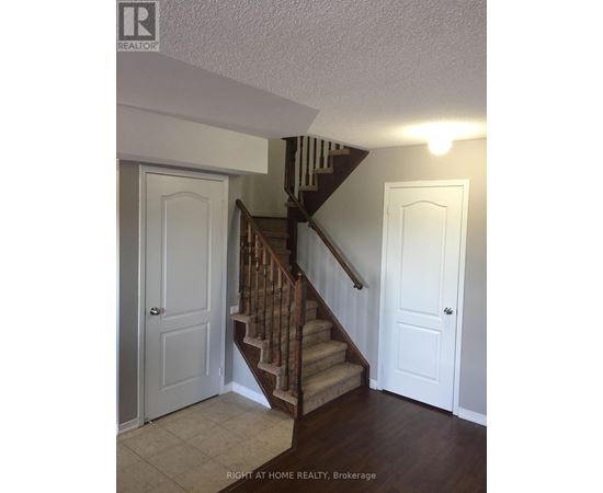 A staircase with a white door on the left and a white door on the right.