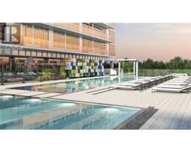 A modern building with a pool in front and a sign that says "REALTOR".