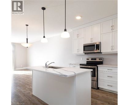 A kitchen with white cabinets and a white island.