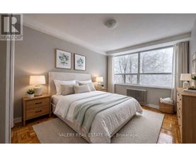 A bedroom with a large bed, two nightstands, and a window.