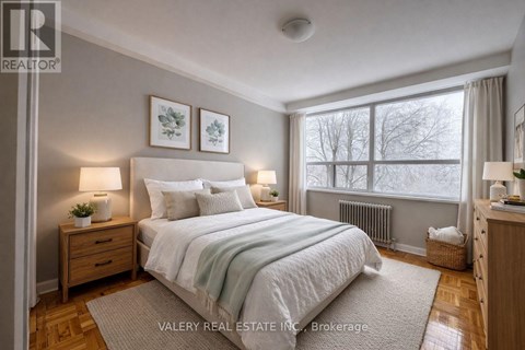 A bedroom with a large bed, two nightstands, and a window.