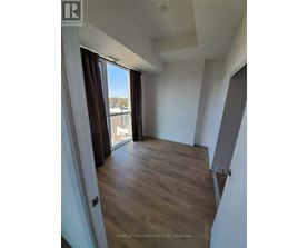 A room with a slanted ceiling and wooden flooring.