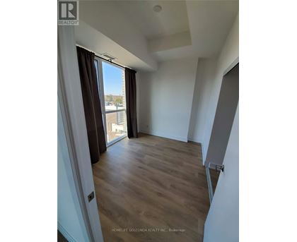 A room with a slanted ceiling and wooden flooring.