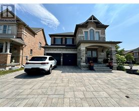 A white car is parked in front of a two-story house.