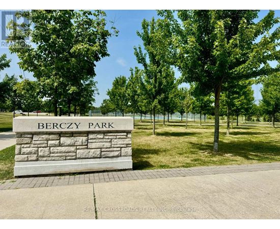Berczy Park is a beautiful park with a stone sign and trees.