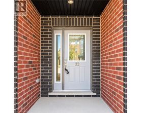 A white door with a black handle is set in a brick wall.