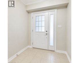 A white door with a glass panel is in a room with white walls.