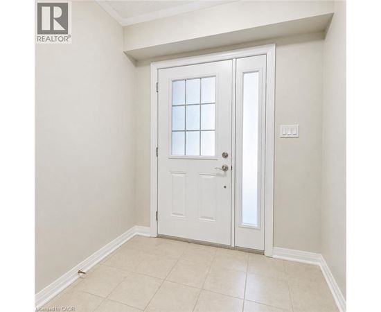 A white door with a glass panel is in a room with white walls.