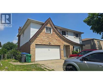 A house with a garage and a car parked in front.
