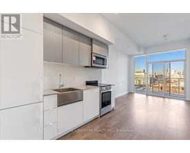 A modern kitchen with white cabinets and a stainless steel sink.