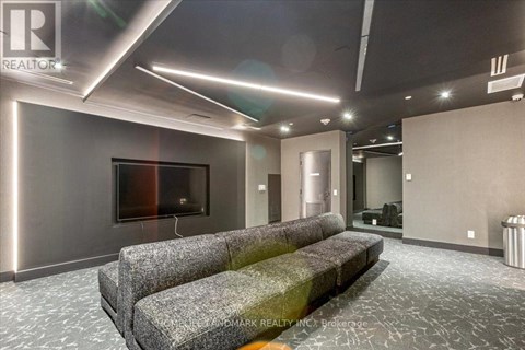 A modern living room with grey couches and a flat screen TV.