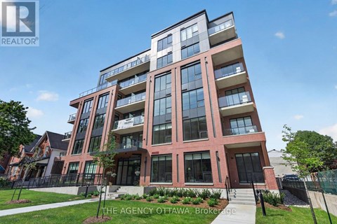 A modern multi-story building with a glass facade and a red brick exterior.