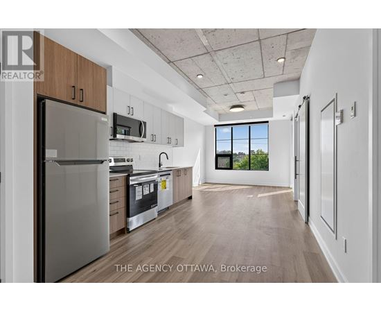 A modern kitchen with wooden cabinets and stainless steel appliances.