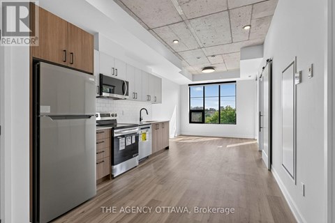A modern kitchen with wooden cabinets and stainless steel appliances.