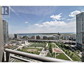 A view from a high-rise building looking down at a cityscape with a large open green space in the foreground.