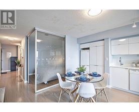 A dining room with a glass table and chairs.