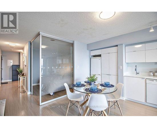 A dining room with a glass table and chairs.