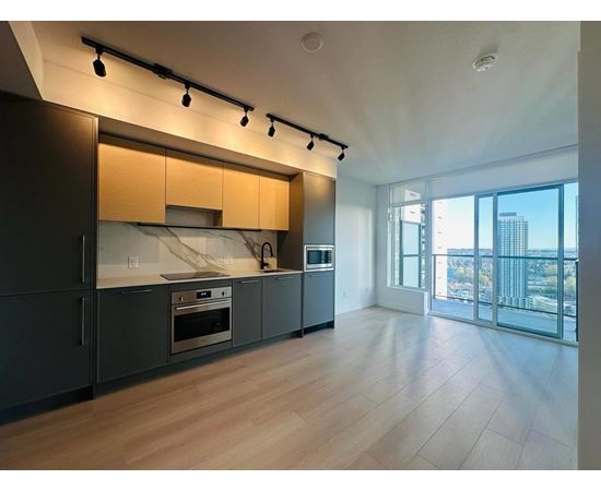 A modern kitchen with wooden cabinets and a large window overlooking the city.