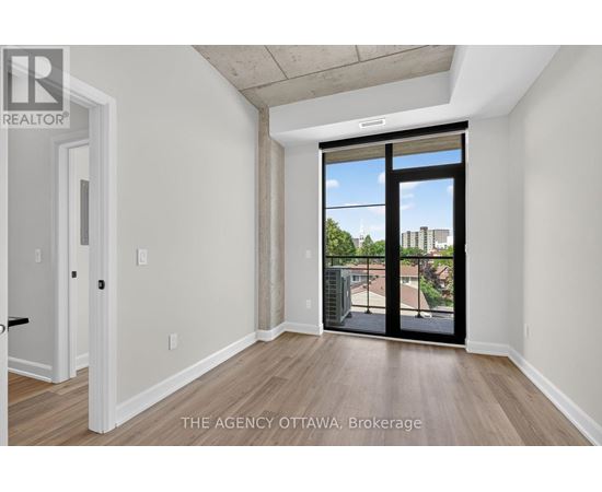 A room with a sliding glass door leading to a balcony.