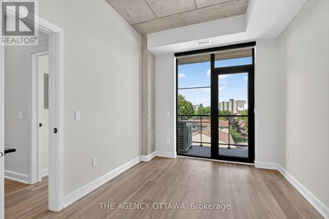 A room with a sliding glass door leading to a balcony.