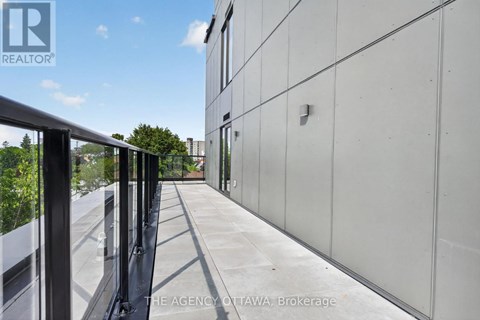 A balcony with a metal railing and a glass door.