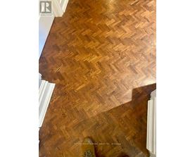 A wooden floor with a herringbone pattern.