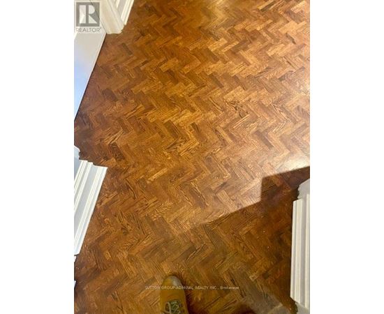 A wooden floor with a herringbone pattern.