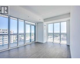 A spacious room with large windows overlooking a cityscape.