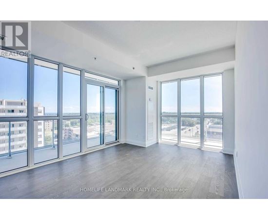 A spacious room with large windows overlooking a cityscape.