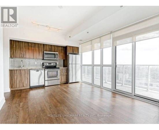 A spacious kitchen with wooden cabinets and stainless steel appliances.