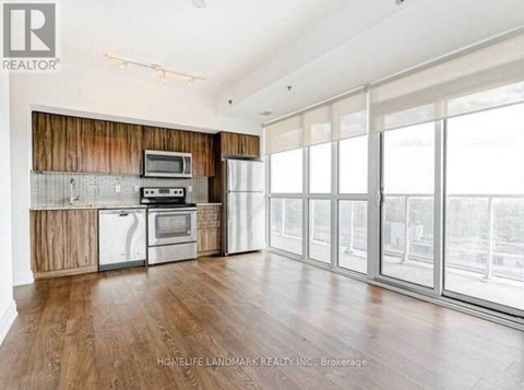 A spacious kitchen with wooden cabinets and stainless steel appliances.