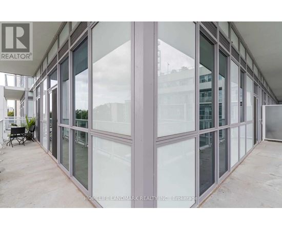 A glass wall of a building with a Realtor sign on it.