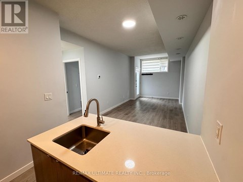 A kitchen with a sink and a countertop.