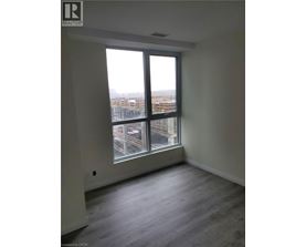 A room with a large window overlooking a cityscape.