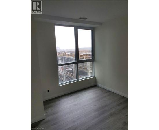 A room with a large window overlooking a cityscape.
