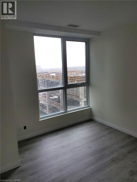 A room with a large window overlooking a cityscape.